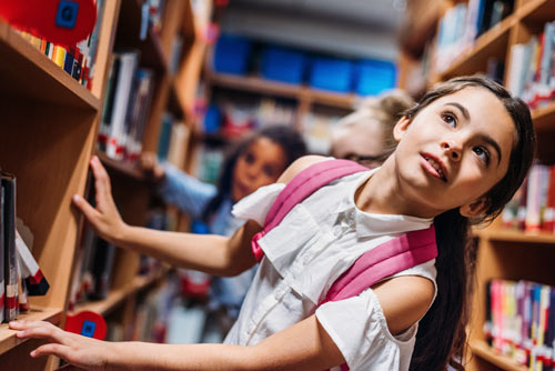 Little Girl in Library Looking Up